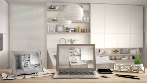 istock Architect designer desktop concept, laptop and tablet on wooden work desk with screen showing interior design project and CAD sketch, blurred draft in the background, modern kitchen idea template 1069912836