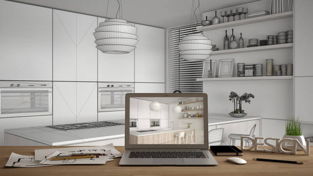 istock Architect designer desktop concept, laptop on wooden work desk with screen showing interior design project, blueprint draft in the background, modern white and wooden kitchen 1069912846