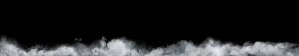 Photo of Panoramic view of the abstract fog or smoke move on black background. White cloudiness, mist or smog background.