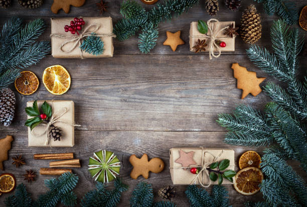 istock Christmas frame, background with decorations. Christmas gift, pine cones, fir branches, gingerbreads on wooden background. Retro style. 1069913292