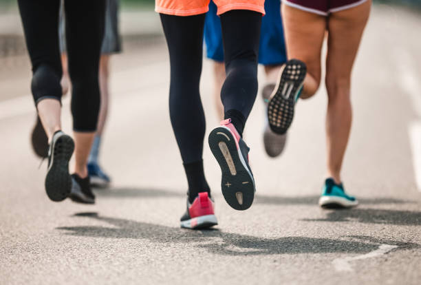 istock Large group of unrecognizable marathon runners having a race on the road. 1069919262