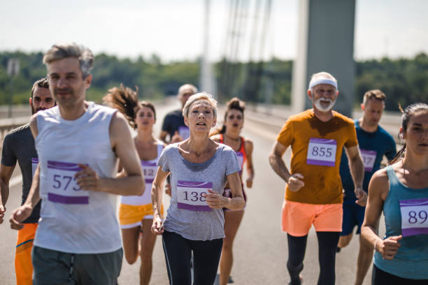 istock Large group of mix-aged marathon runners on a bridge. 1069919730