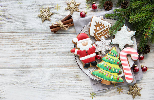 Christmas cookies and Christmas tree Christmas cookies and Christmas tree on a old wooden table christmas cookies stock pictures, royalty-free photos & images