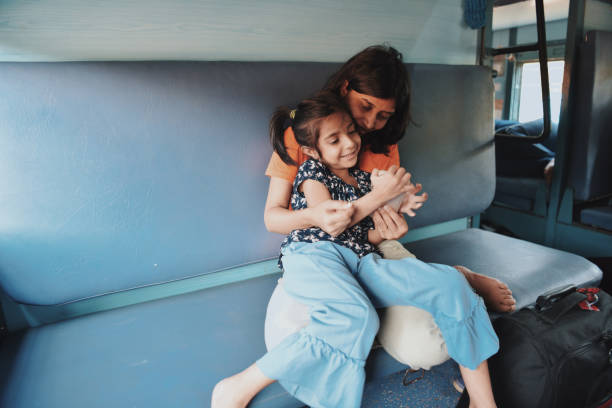 istock Mother and daughter share intimate moment while travelling by train 1069921970