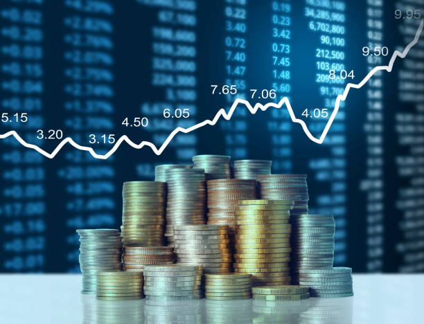 istock Coins graph stock market 1069925312