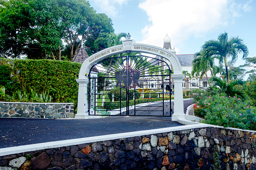 Saint Lucia, Caribbean-December 22, 2013: Government House. Popular tourist cultural monument of the capital of Saint Lucia-the residence of the Governor-General of the island and the head of the local government. The house was built in 1895 on the famous town hill of Morne fortune, and its crown is clearly visible from all areas of Castries. This is one of the few buildings in the Victorian style, preserved on the island. Part of the building is reserved for the Royal Museum (La Pavilion Royal Museum). In addition to the openwork crown, the building is decorated with the Royal coat of arms.