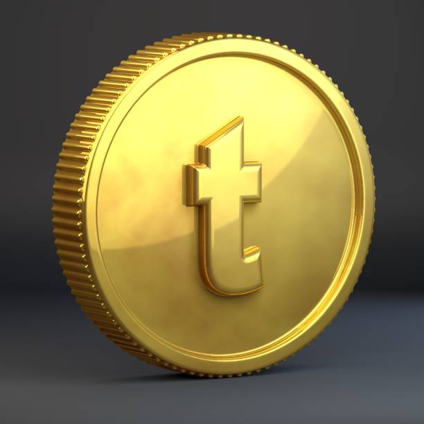 istock Golden coin with letter T lowercase isolated on black background. 1069936498