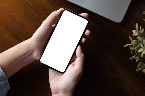 istock Close up Woman hand Using a Smart Phone with blank screen at office. 1069938226