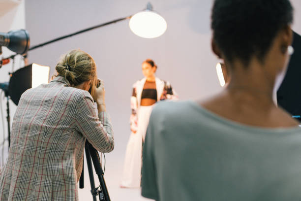 fotógrafo en una sesión con un modelo - a la moda fotos fotografías e imágenes de stock