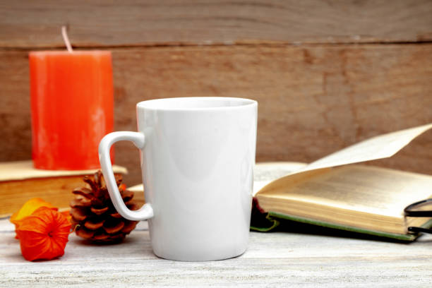 istock Mug mockup - design template, white cup on a wooden background 1069940188