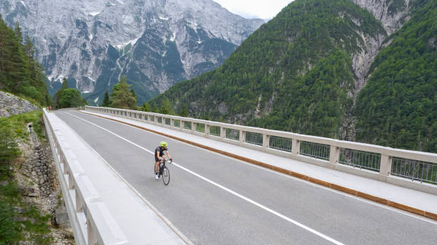 istock Man riding road bike on bridge 1069941292
