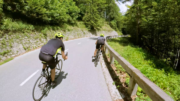istock Two men riding road bikes on mountain road 1069941300