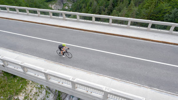 istock Man riding road bike on bridge 1069941340