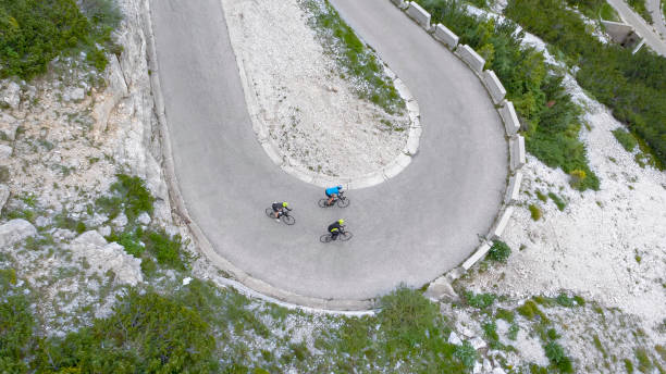 istock Group of road cyclists riding up mountain road 1069941378