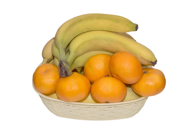istock ripe tangerines and bananas in a basket isolated 1069943328