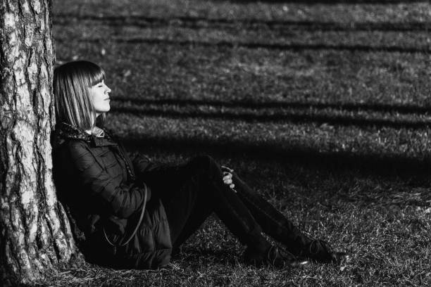 istock The girl sits on a green lawn 1069946002