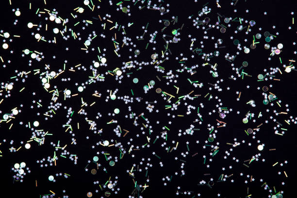 istock Holographic sparkles, stars and confetti on black background. 1069948790