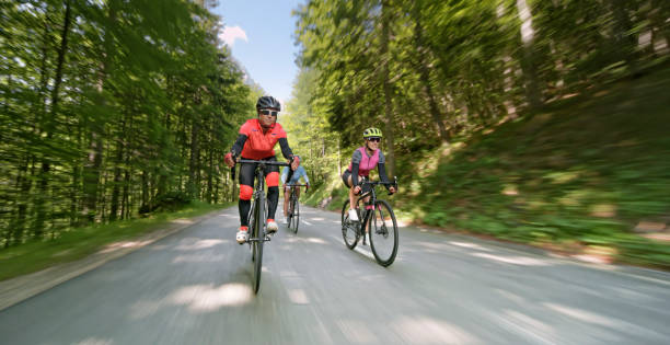 istock Three women riding road bikes on mountain road 1069952808