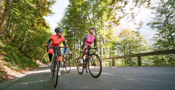 istock Three women riding road bikes on mountain road 1069952824