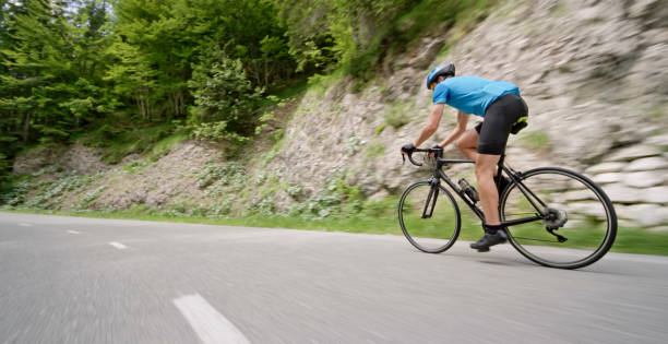Man riding road bike on mountain road