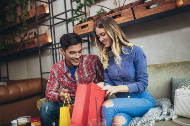 istock Young couple enjoying in modern cafe after shopping. 1069953546