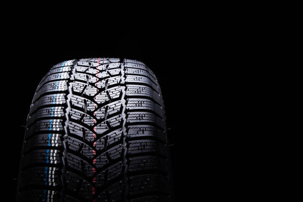 istock Winter Car tires on black background 1069953624
