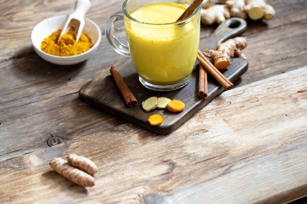 Golden milk with cinnamon, ginger and turmeric stock photo