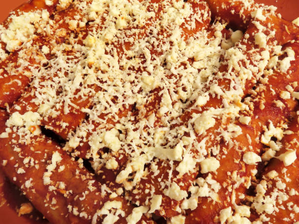 istock Spicy Red Cheese Enchiladas Topped With Cheese 1069958568