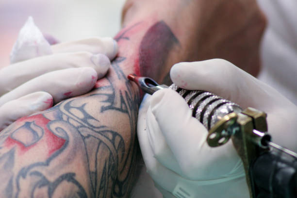 istock tattoo set with a needle and some skin 1069958964