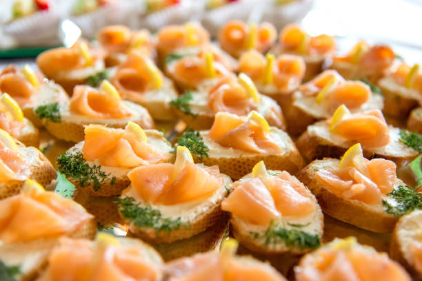 istock Close up of small canapes arranged on a mirror plate over light background - selective focus 1069959104