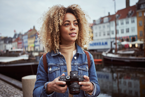 Shot of an attractive young woman out with her camera in a foreign city