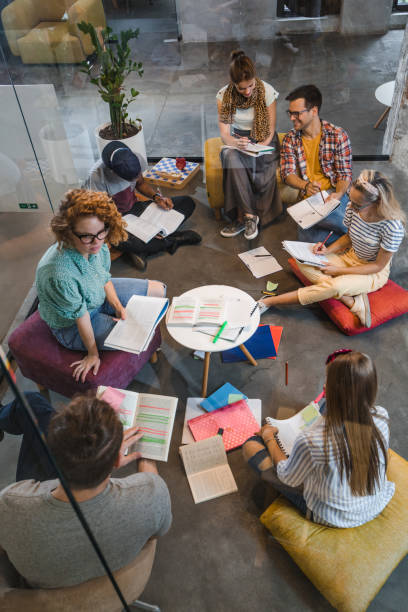 istock Above view of college students studying on the floor at campus. 1069963038