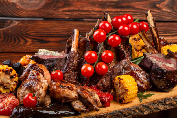 istock Mixed Grilled meat and vegetables on wooden background 1069971398