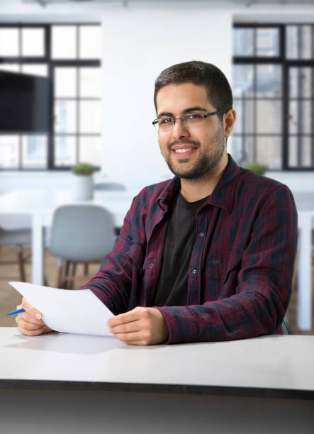 istock Young Man Sitting at a Desk 1069973870