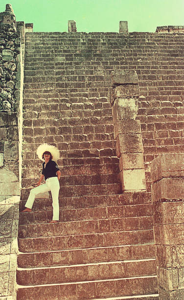 Vintage image of a Woman climbing an ancient Mexican ruin