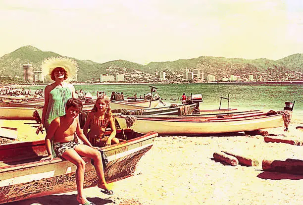 Vintage image of a mother and her children during a summer vacation in the seventies / eighties.