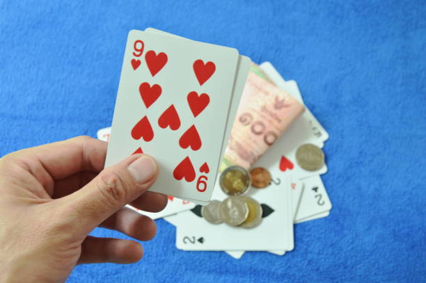 close up of hand holding nine in baccarat games