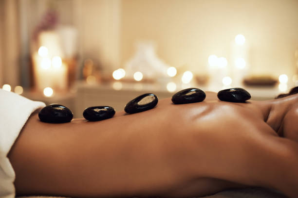 Closeup shot of a woman getting a hot stone massage at a spa