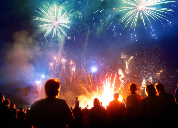 istock Firework Display With Celebrating People And Sparkler New Year 2019 1069988270