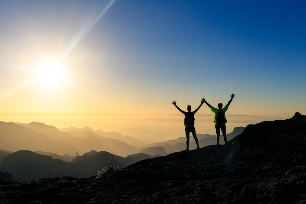 istock Couple hikers success and trust concept in mountains 1069988678