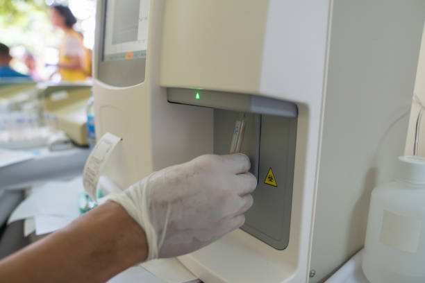 istock Doctor hand performing a blood test with hematological counter machine 1069992288
