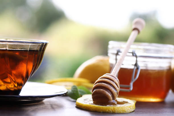 istock Fresh honey with a cup of black tea 1069992330