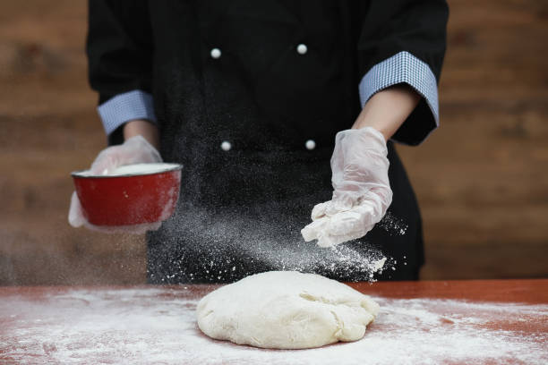 istock the cook makes flour for baking on the table 1069993492