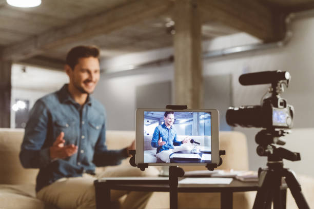 istock Male vlogger recording content on camera 1069993670