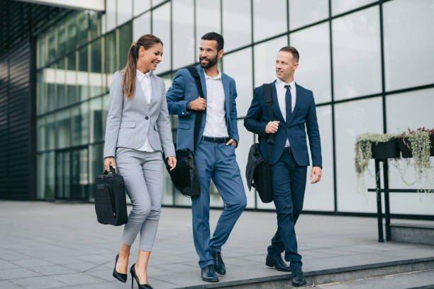istock Three business colleagues having discussion while walking outdoors 1069993852