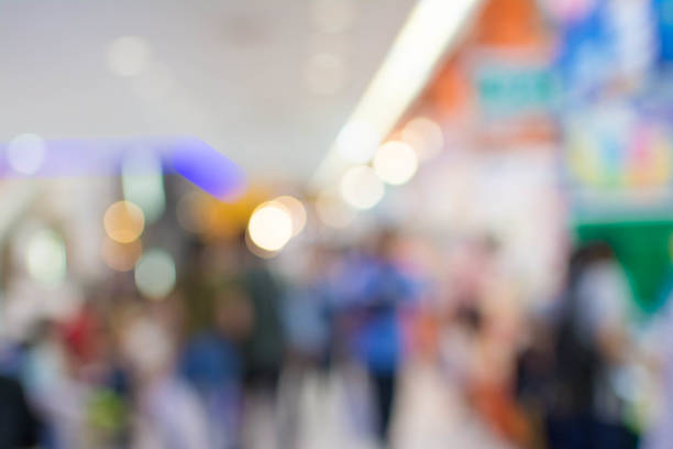 istock Abstract people walking in exhibition blurred background 1069995950