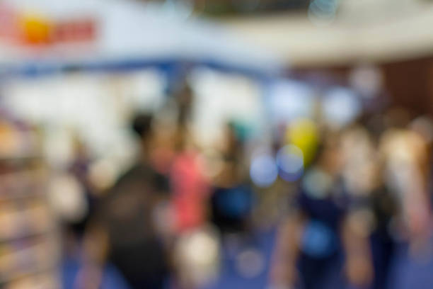istock Abstract people walking in exhibition blurred background 1069996092
