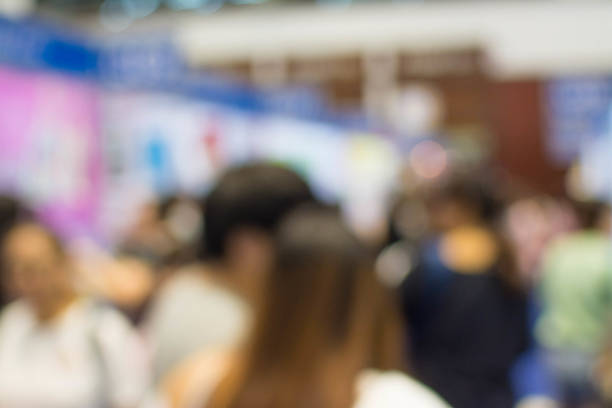 istock Abstract people walking in exhibition blurred background 1069996114