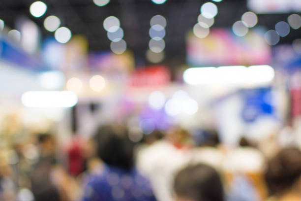 istock Abstract people walking in exhibition blurred background 1069996126
