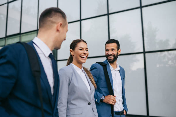 istock Three business colleagues having discussion while walking outdoors 1069996888